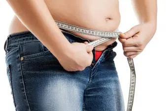 overweight-woman-measuring-waist.jpg