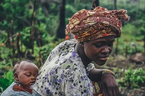 A mother with a baby strapped to her back...