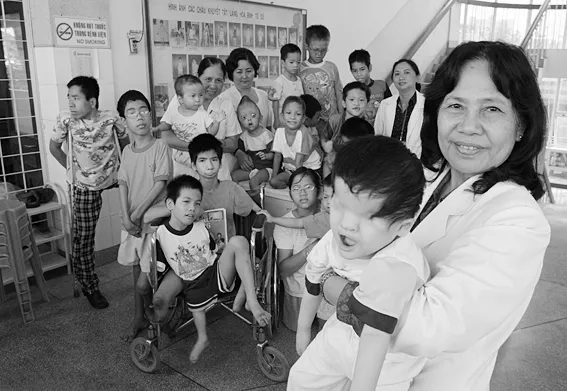 A_vietnamese_Professor_is_pictured_with_a_group_of_handicapped_children.jpg