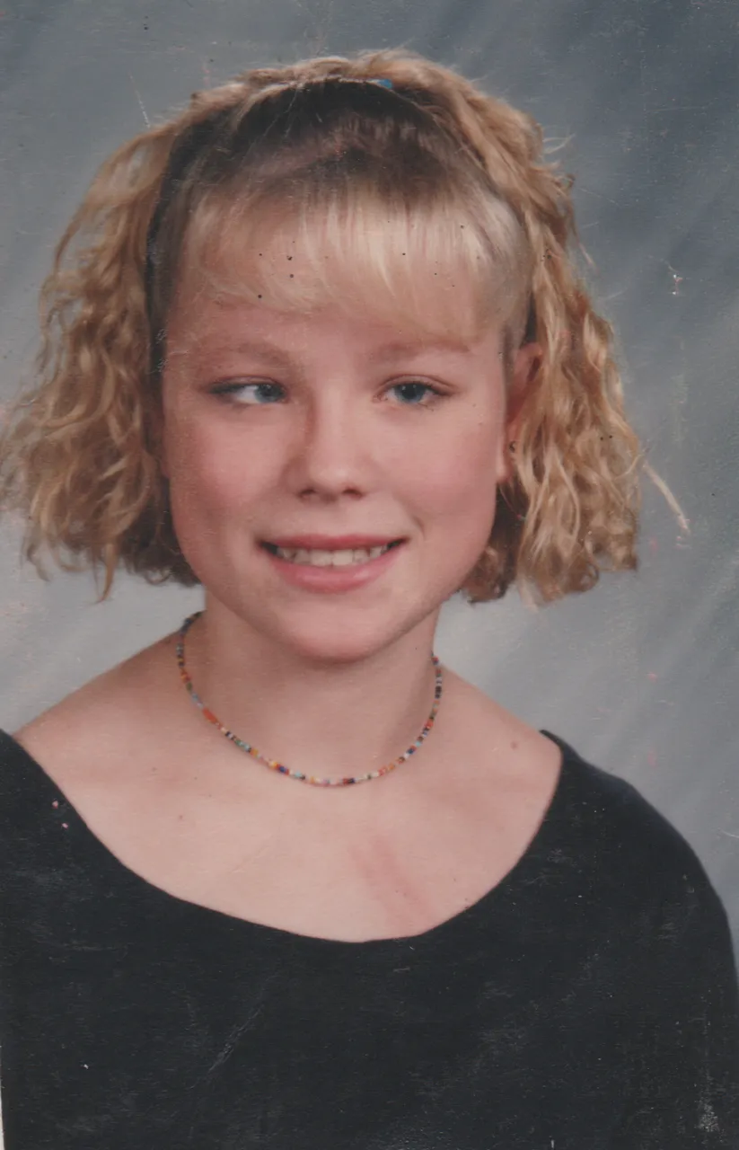 1994-10 - Katie Arnold, not sure what year or month, no glasses, frizzy blond hair, black top, necklace.png