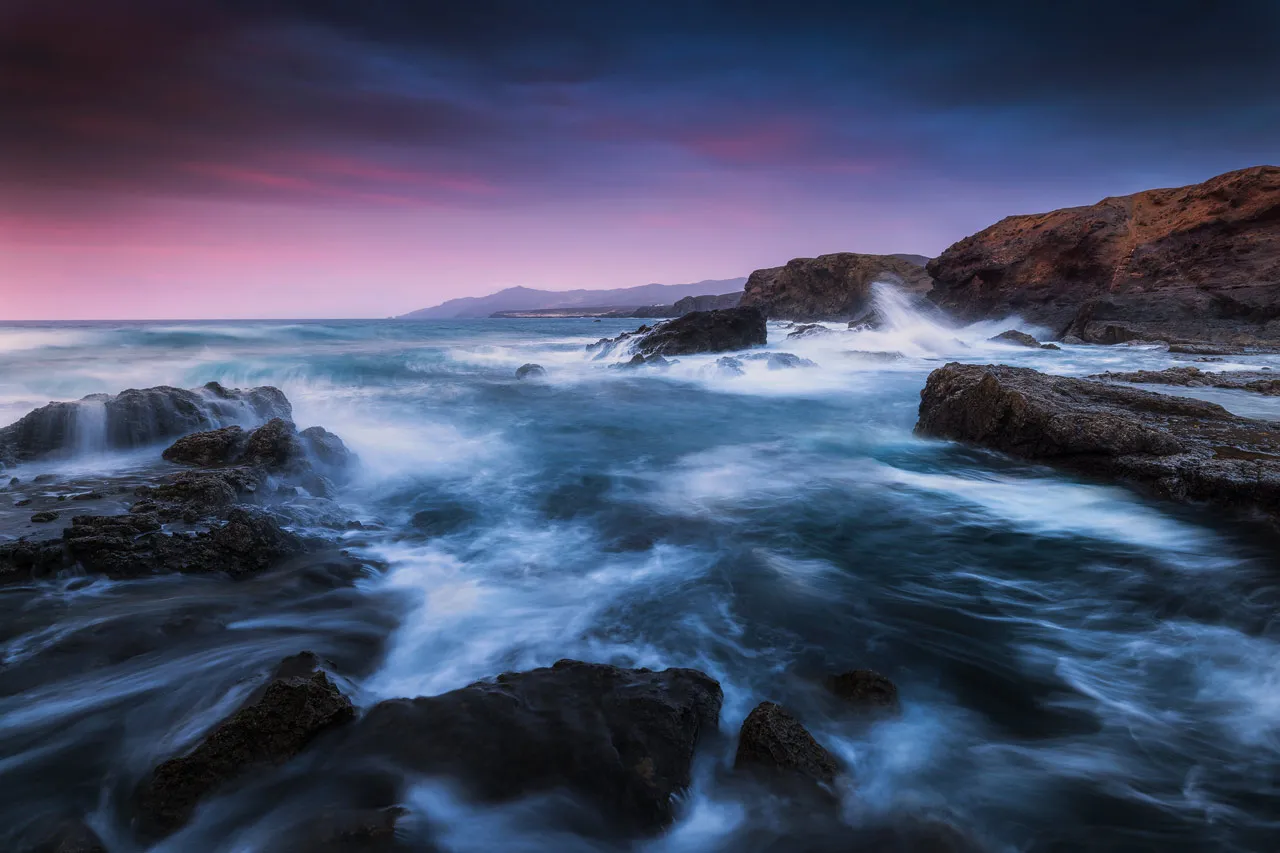 Stormy sea near La Pared with magenta colored sky above