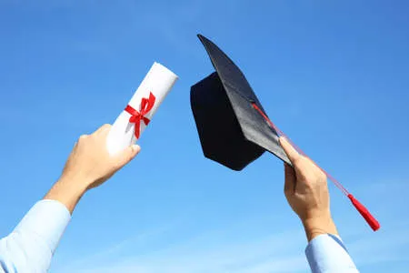 132634266-estudiante-con-sombrero-de-graduación-y-diploma-contra-el-cielo-azul-primer-plano.jpg