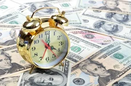 15736321-alarm-clock-for-dollar-banknotes-close-up.jpg