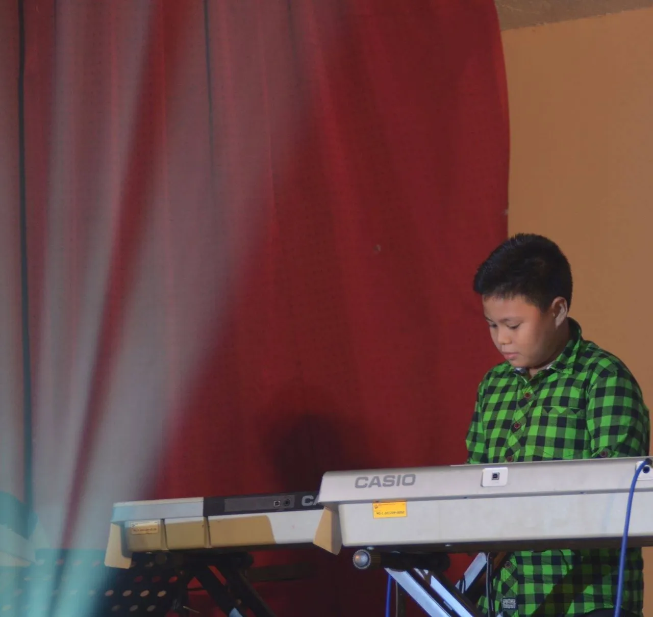 Adrian playing the keyboards at 9 yrs old.jpg