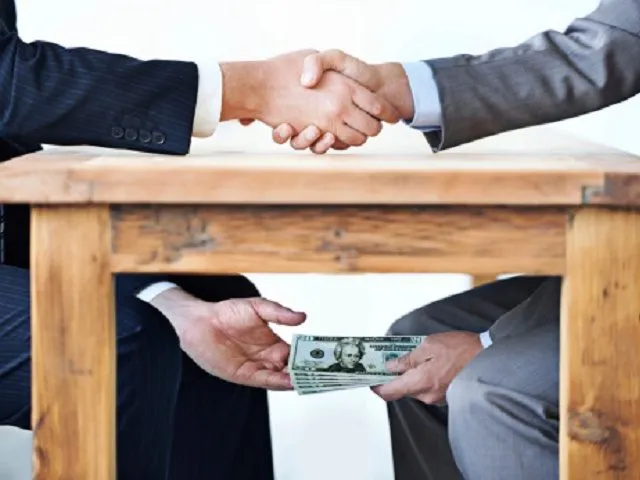 2078959374_Pic-of-Bribery-corruption-money-under-table.jpg