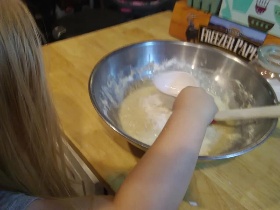 bread naan 4 sophie holding yogurt to pour in.jpg