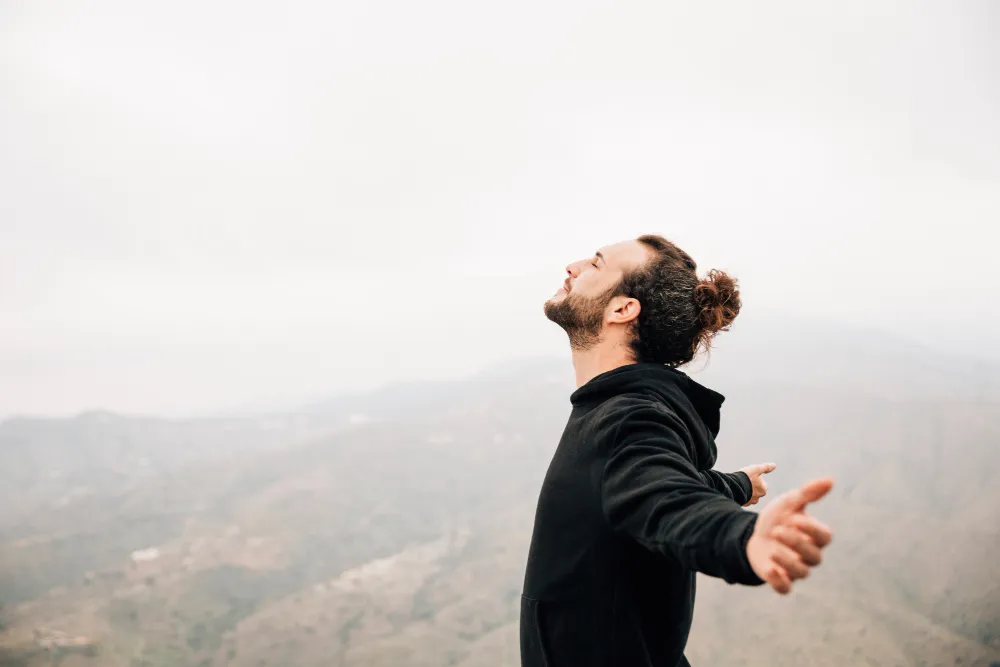 side_view_carefree_man_enjoying_freedom_with_arms_outstretched_1_.jpg