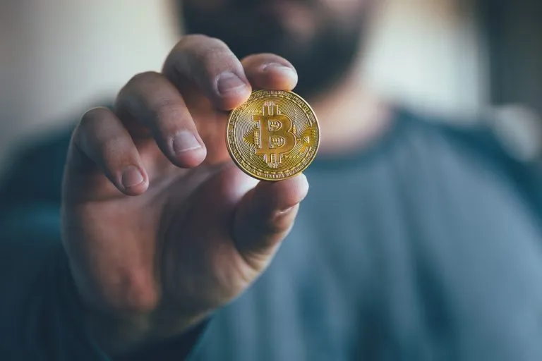 Bitcoin-man-hand-768x512.jpg