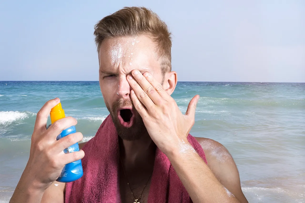A person puts sunscreen on.
