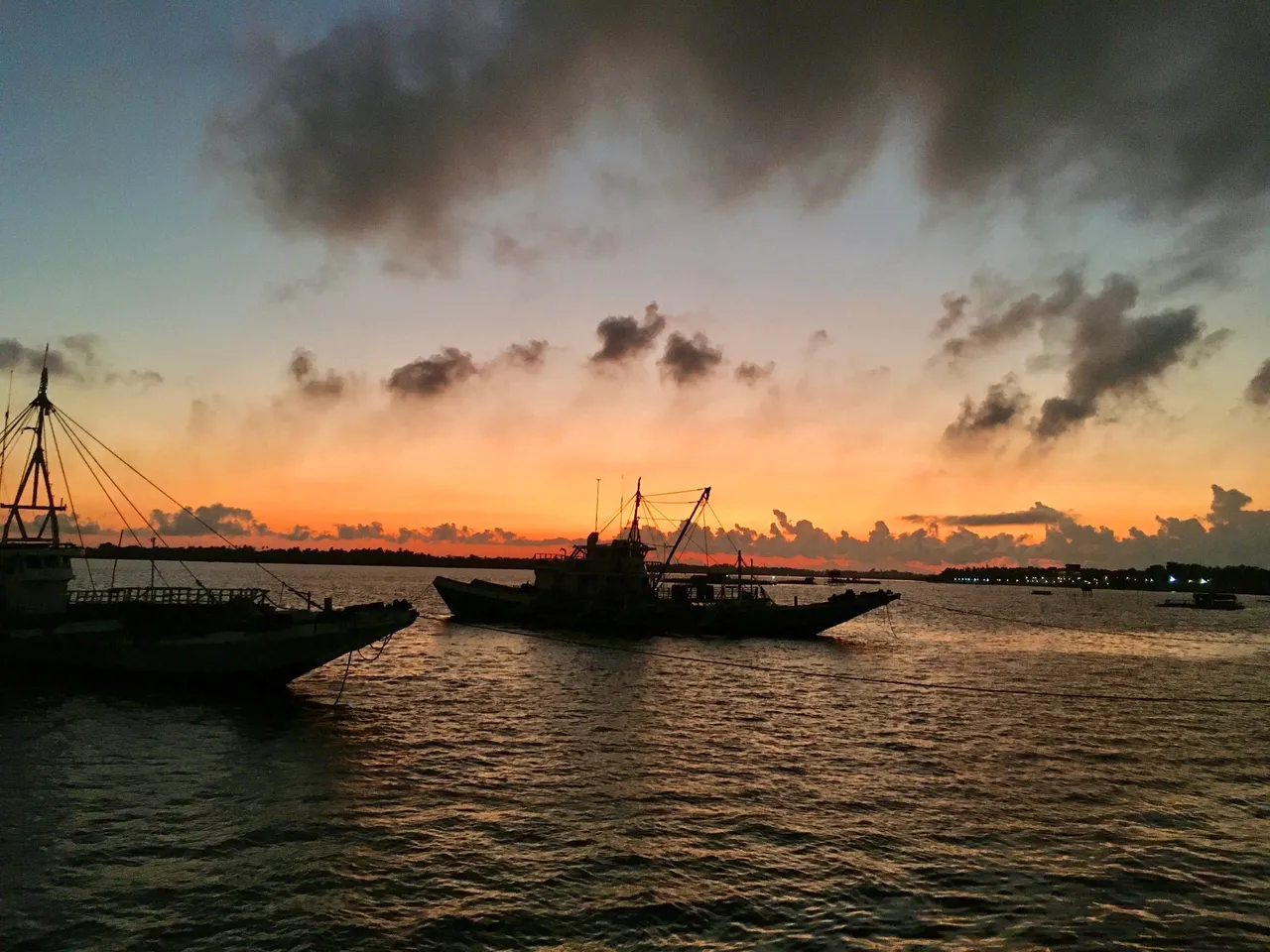 The majestic sunrise at Hagnaya Port. It spews vibrant yellow-orange sunlight