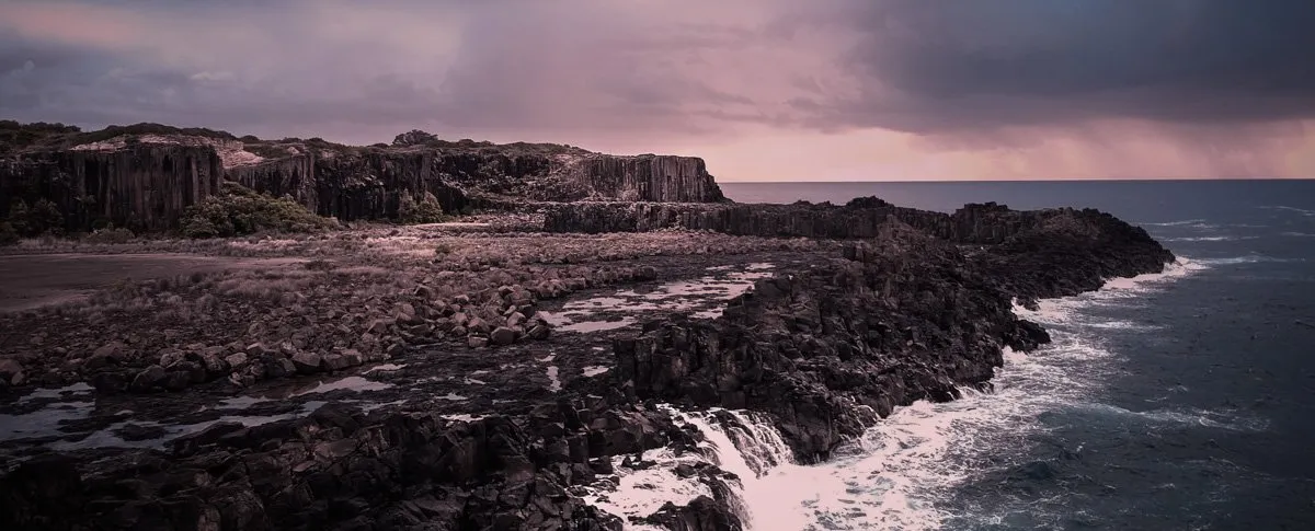 Waves crashing against rocks at Bombo Quarry near Kiama on the New South Wales South Coast