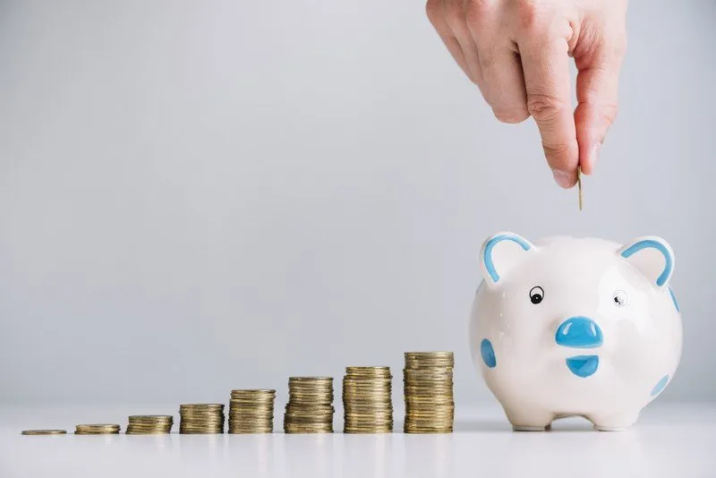 humanhandinsertingcoinpiggybank.jpg