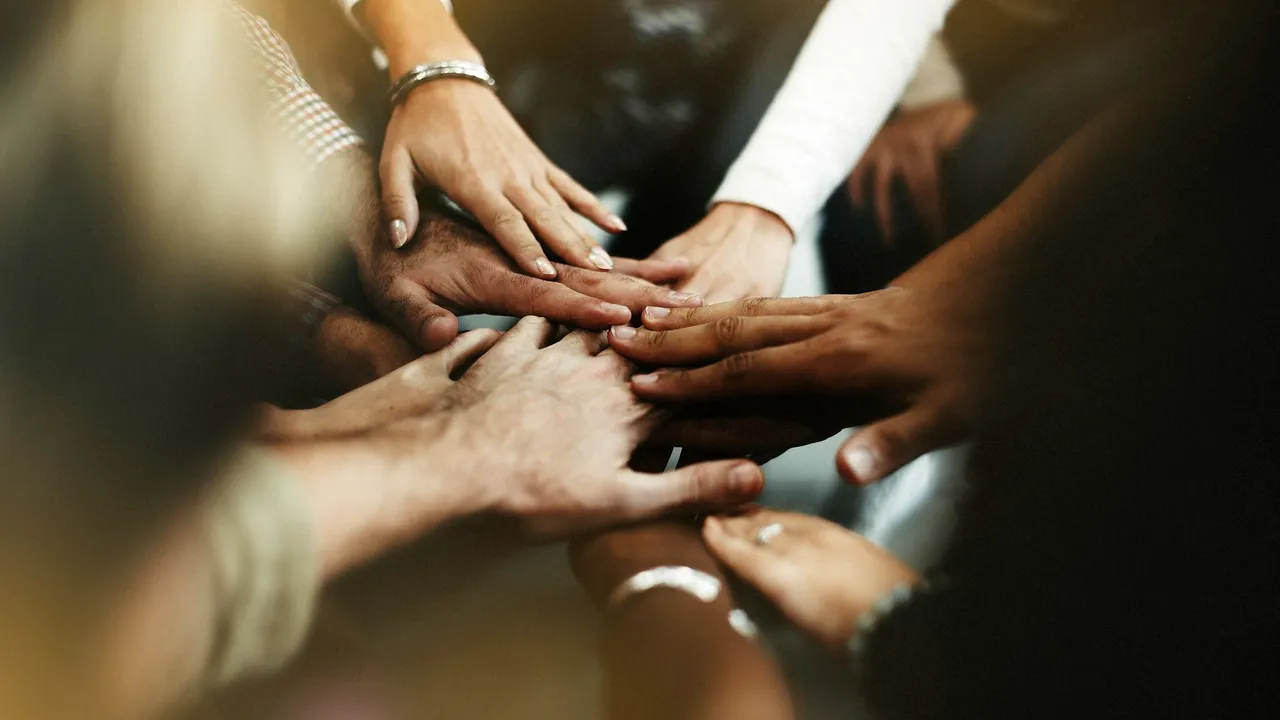 closeup-of-diverse-people-joining-their-hands.jpg