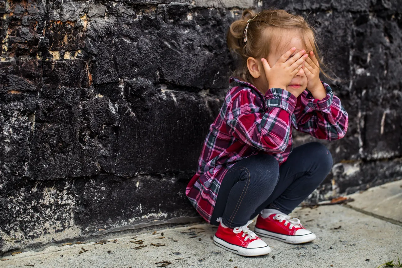 little-beautiful-girl-near-brick-wall.jpg