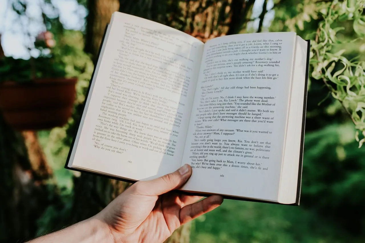 kaboompics_Man reading a book outdoors.jpg