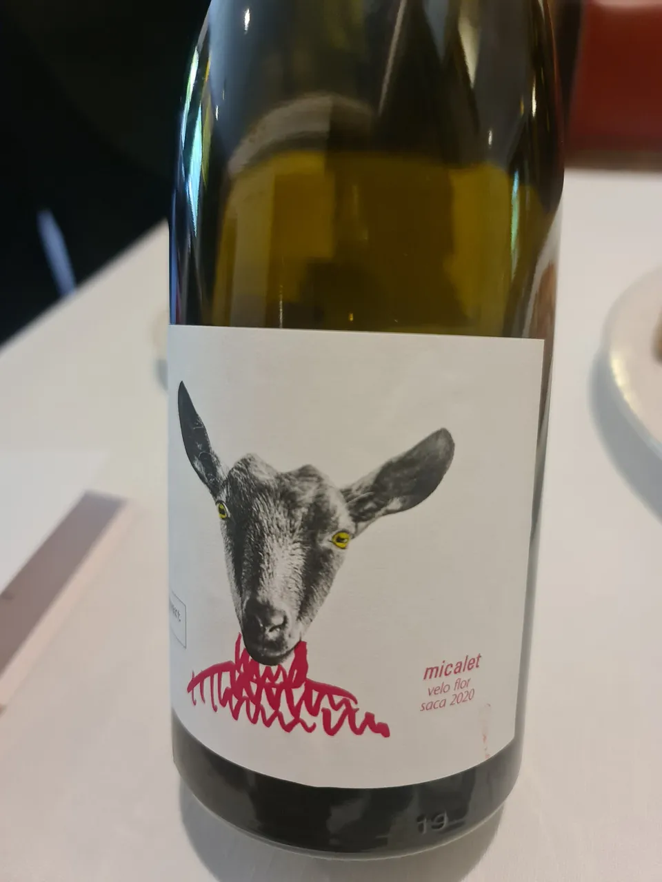 Glass of Micalet white wine, special batch aged under a veil of flor, by Javi Revert winemaker - Enchanting Parker Guide wine tasters since 2018, year in wich it got rated with 94 points - Javier works with the local grape varieties Tortosí, Trepadell, Malvasía, Merseguera and Verdi - Vineyard is particularly special, as it was planted by Javier’s own great-grandfather in 1948 (glass on the house) (1).