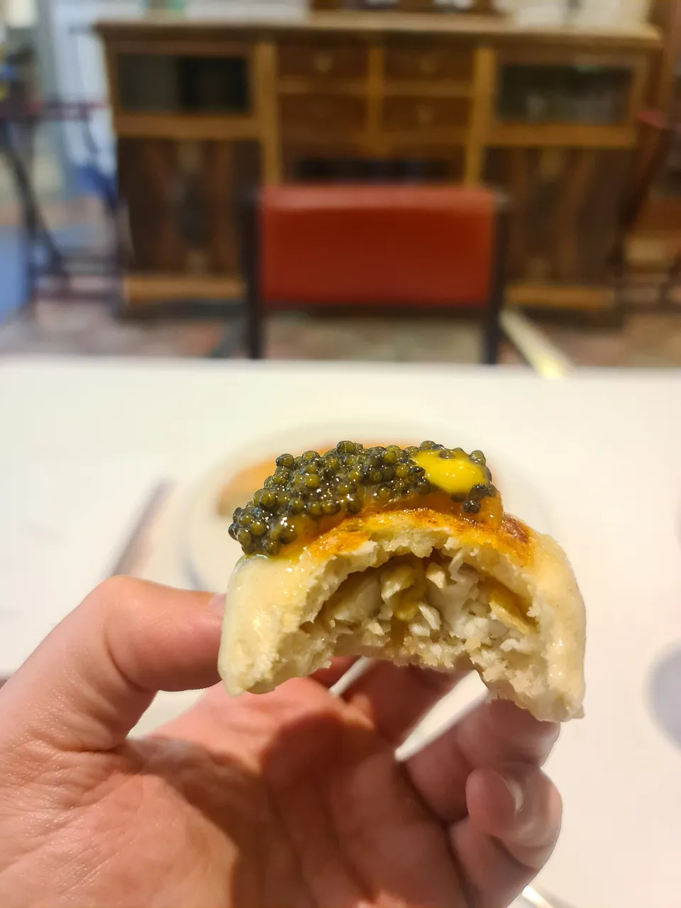Steamed bun stuffed with eel and topped with black lemon meniere and caviar (Fifht main course) (4).