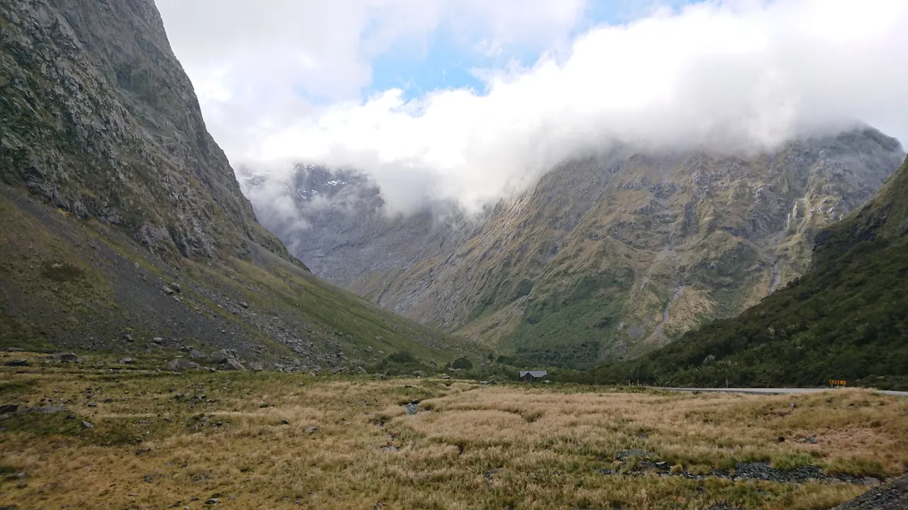 The surrounding ranges shrouded in cloud and mystery