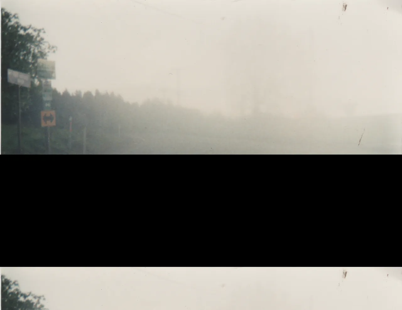 1990s maybe, road, cloudy, yellow road sign, water mud piddle, clouds, trees, not sure when or where, no people in the photo, no date, no info.png