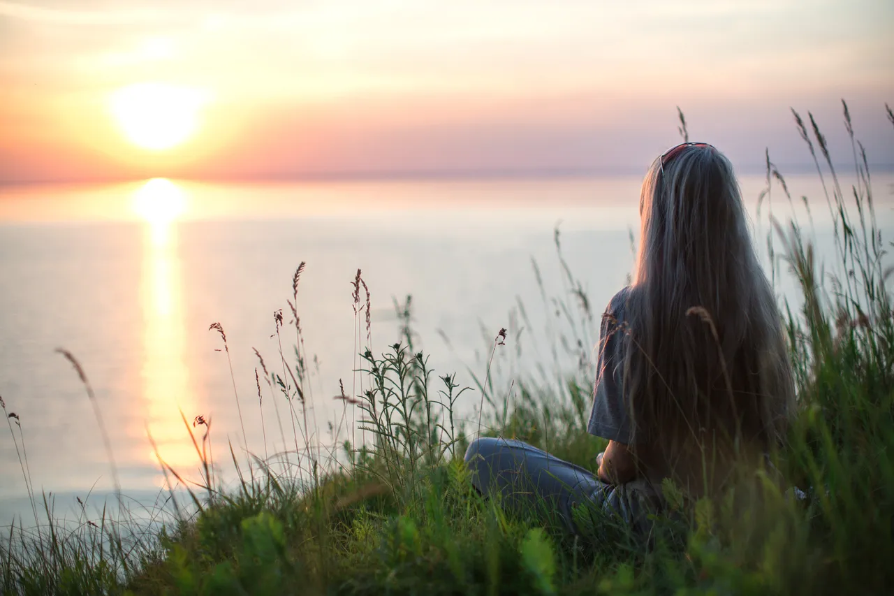 photo-of-woman-sitting-on-grass-during-golden-hour-4640845.jpg