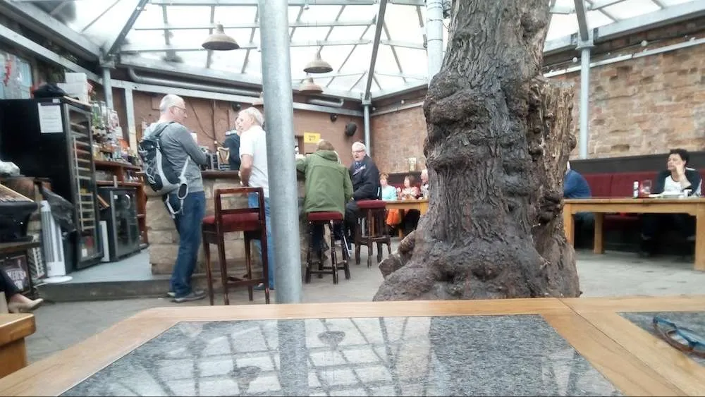 Another one of Alastair and Paul at the bar with tree trunk.jpg