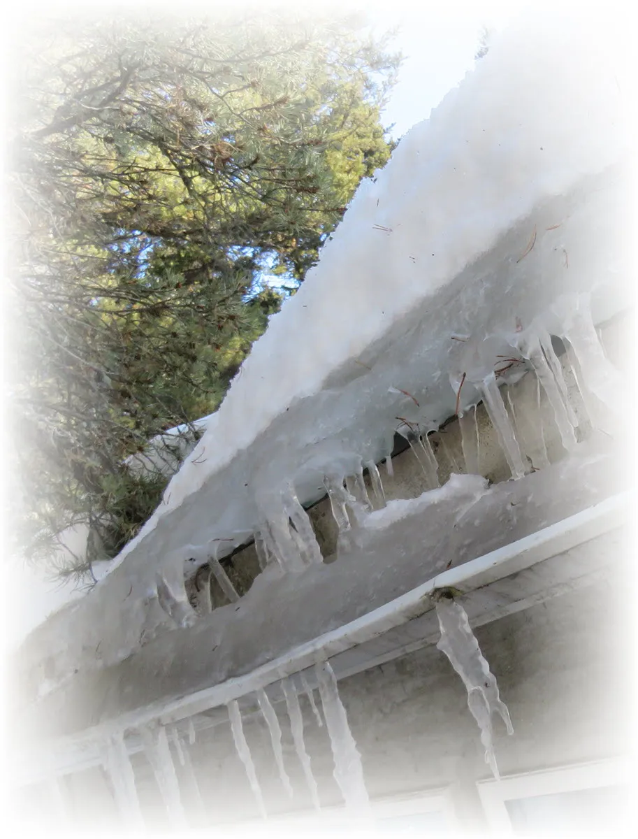 double layer of ice and icicles as snow slides off roof and ice freezes in gutter.JPG