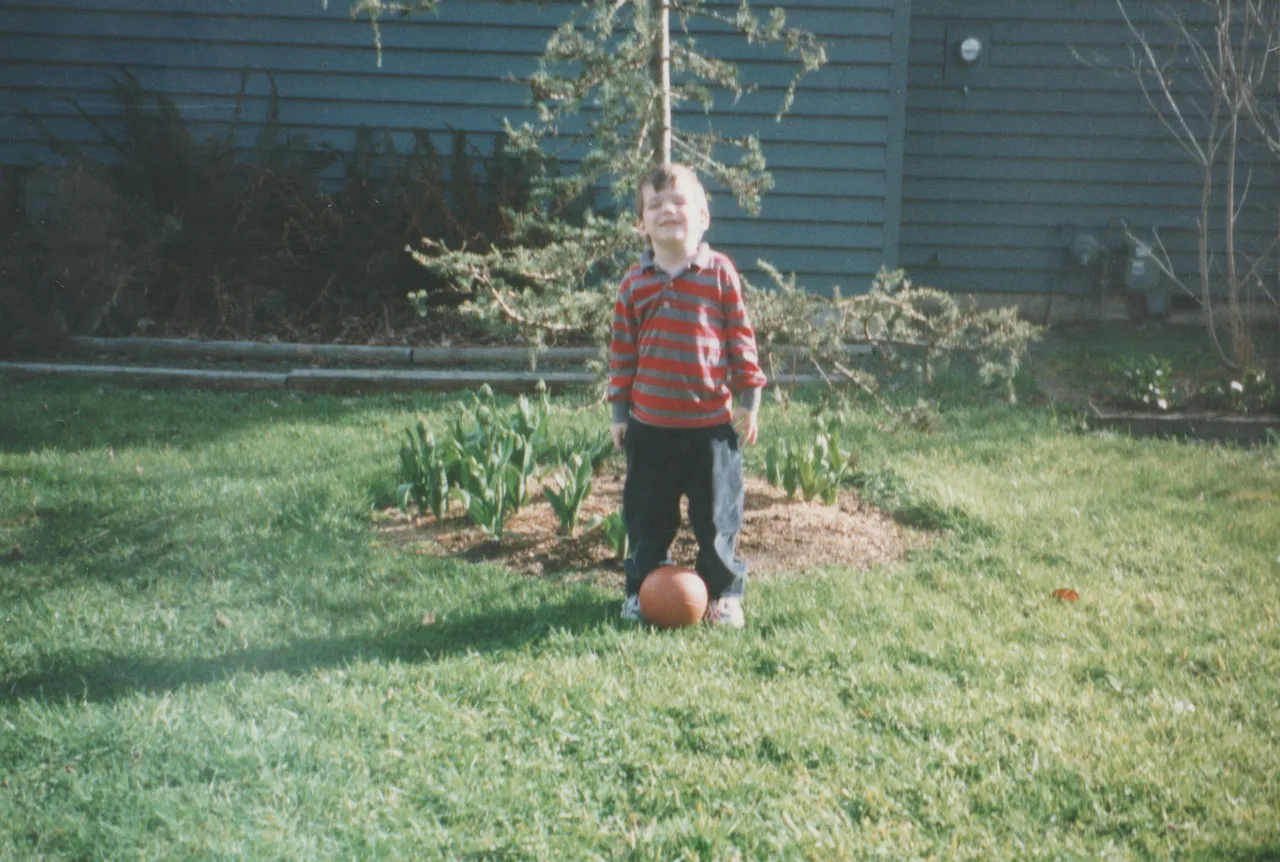 1999-03 - Tyler Williams standing on grass in Karen's backyard.png