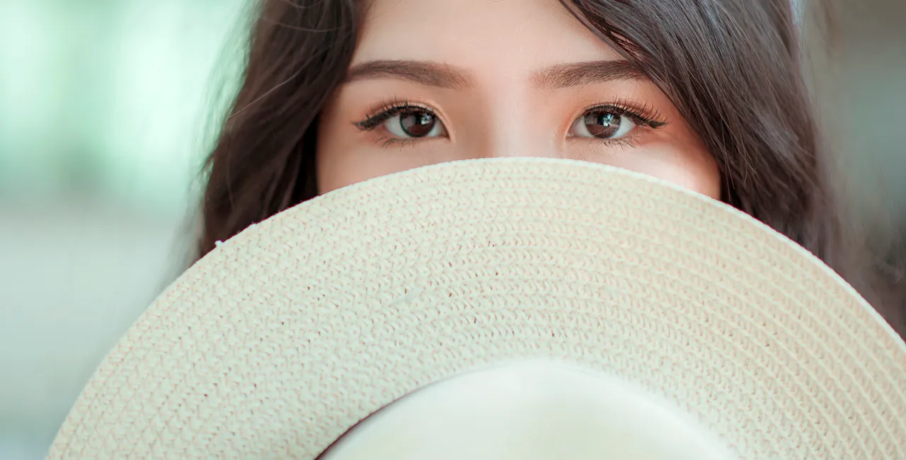 asian-woman-with-hat-covering-face.jpg