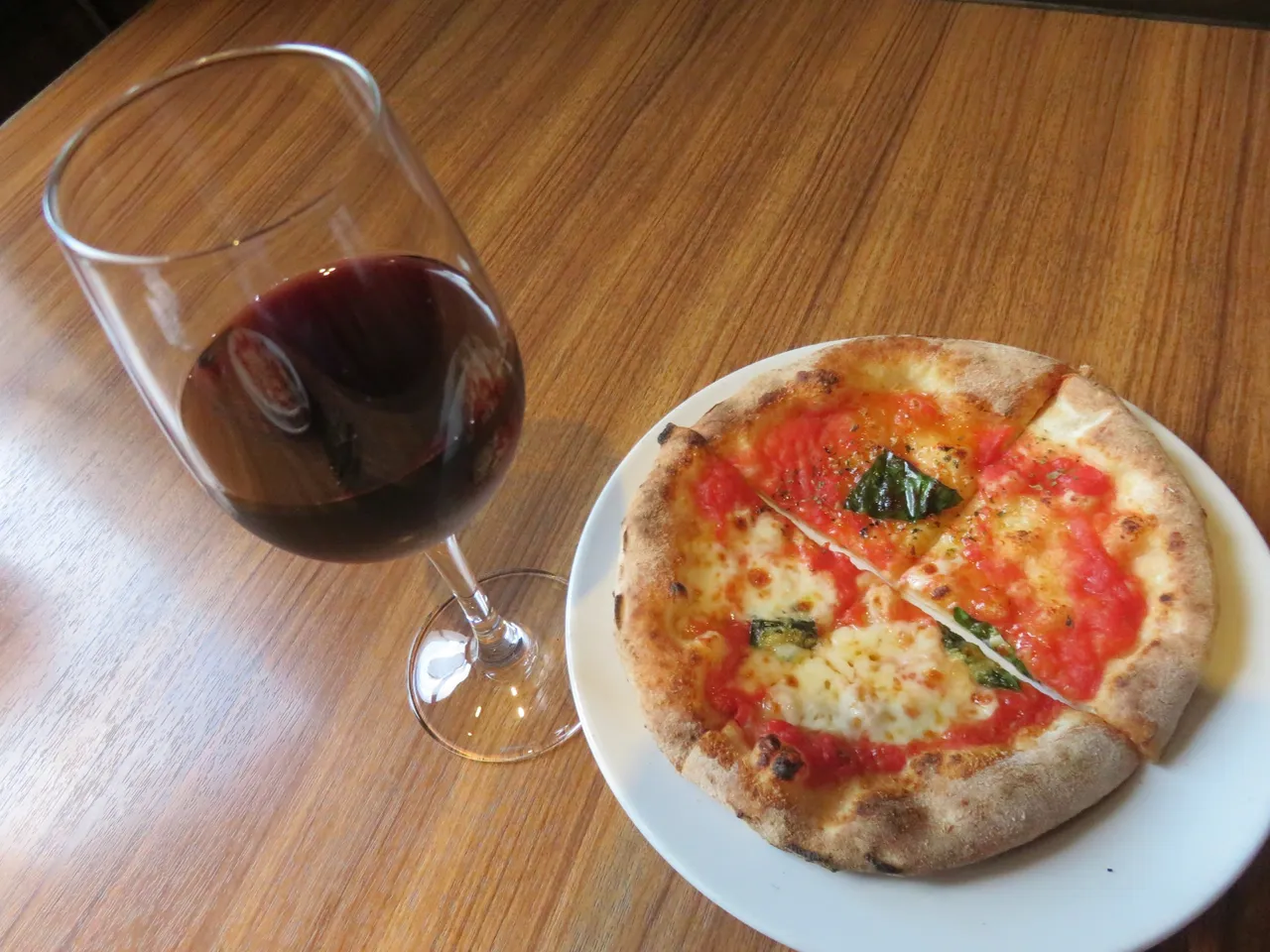 A fantastic pizza with another glass of wine.