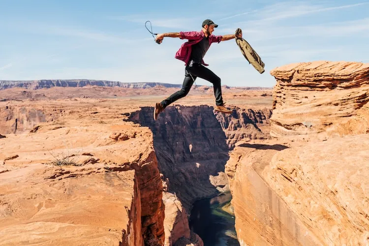 man jumping off cliff