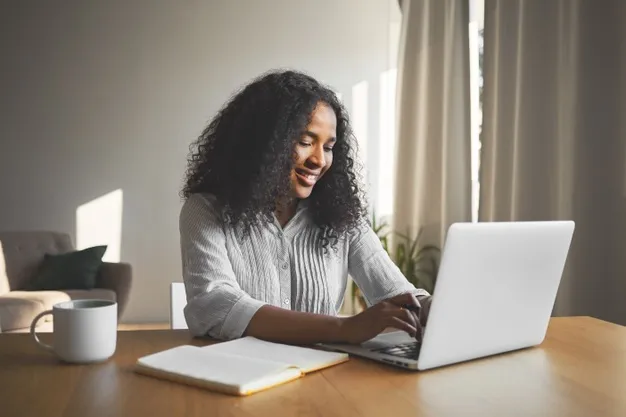 gorgeous-positive-young-dark-skinned-female-blogger-keyboarding-generic-laptop-smiling-being-inspired-while-creating-new-content-her-travel-blog-sitting-desk-with-diary-mug_343059-1535.jpg