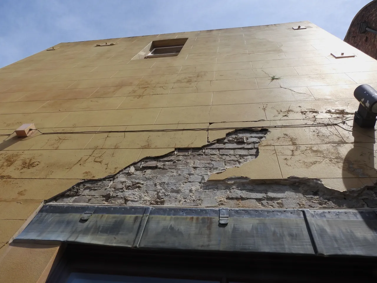 PAINT FALLING OFF WALL.JPG