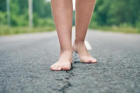 front-view-bare-feet-young-girl-walking-along-asphalt-road-close-up-154509463.jpg