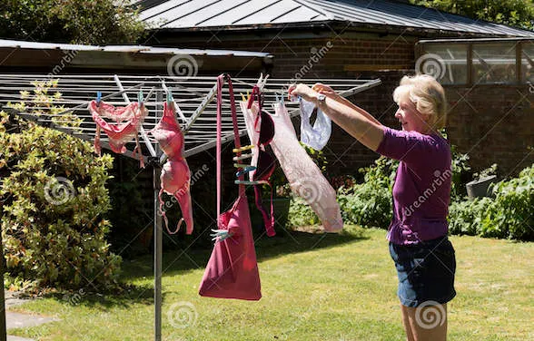 woman-hanging-washing-out-to-dry-rotary-clothes-line-96312553.jpg