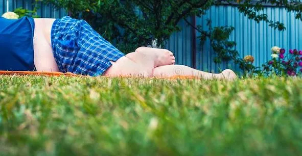 low-angle-view-unrecognizable-barefoot-big-fat-man-blue-shirt-plaid-shorts-lying-mowed-green-grass-lawn-blurred-162376468.jpg