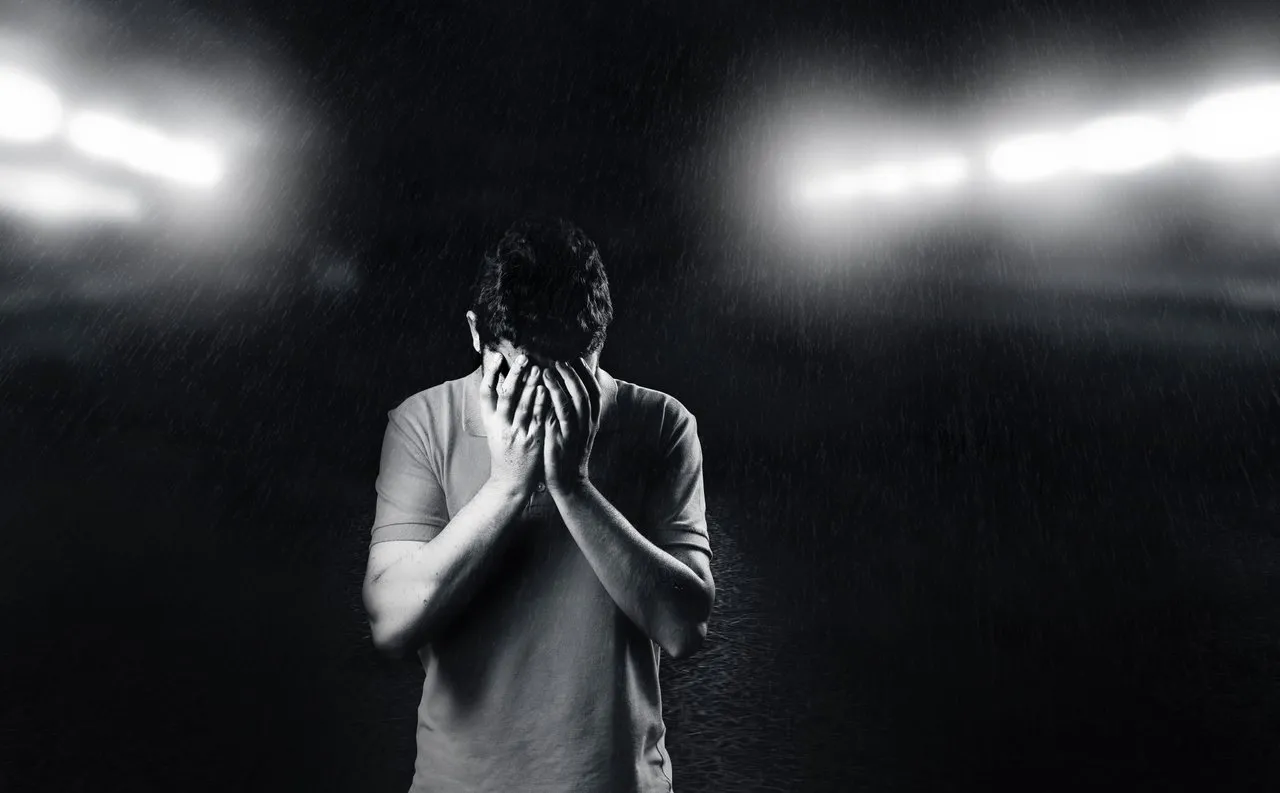 monochrome-photo-of-man-covering-his-face-1556716.jpg