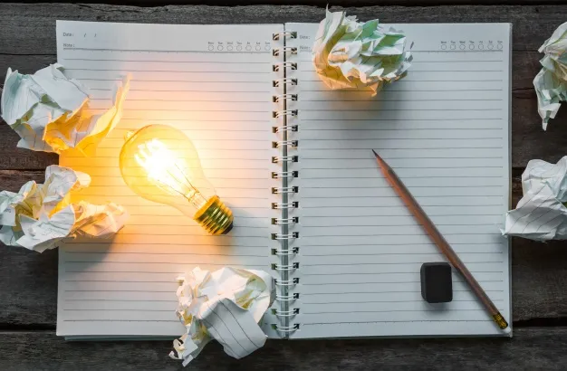 top-view-of-lit-light-bulb-on-a-notebook_1232-673.jpg