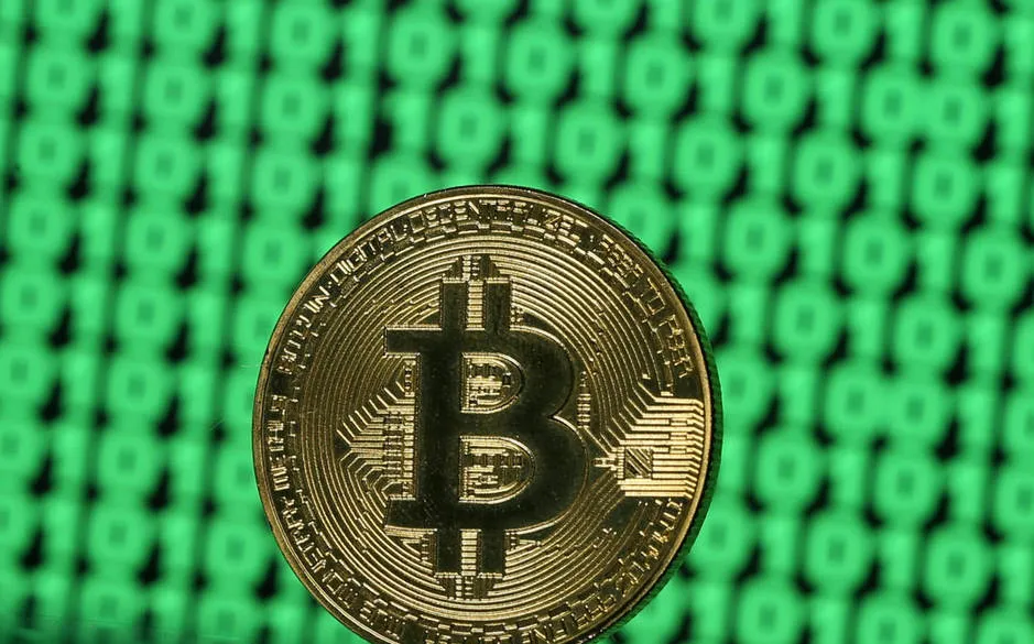 file-photo-a-token-of-the-virtual-currency-bitcoin-is-seen-placed-on-a-monitor-that-displays-binary-digits-in-this-illustration-picture-december-8-2017-reuters-dado-ruvic-illustration-file-photo.jpg