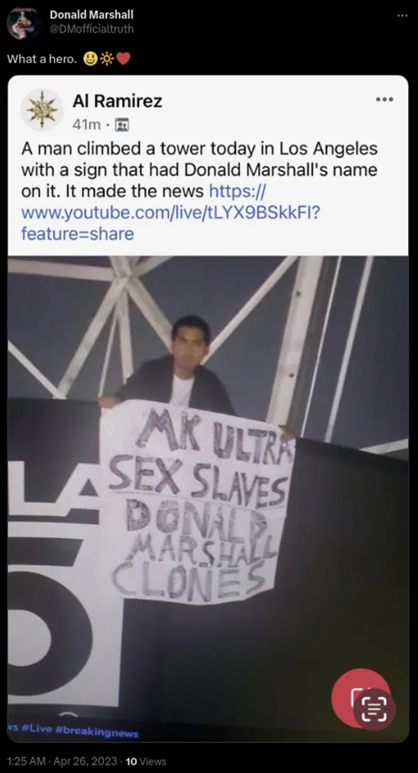 dm-twitter-what-a-hero-man-climbs-los-angeles-tower-with-sign.jpg