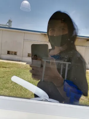 My reflection on the glass window at my workplace