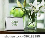 stock-photo-paper-desk-spiral-calendar-with-text-hello-july-on-the-coffee-table-in-the-living-hall-586183385.jpg