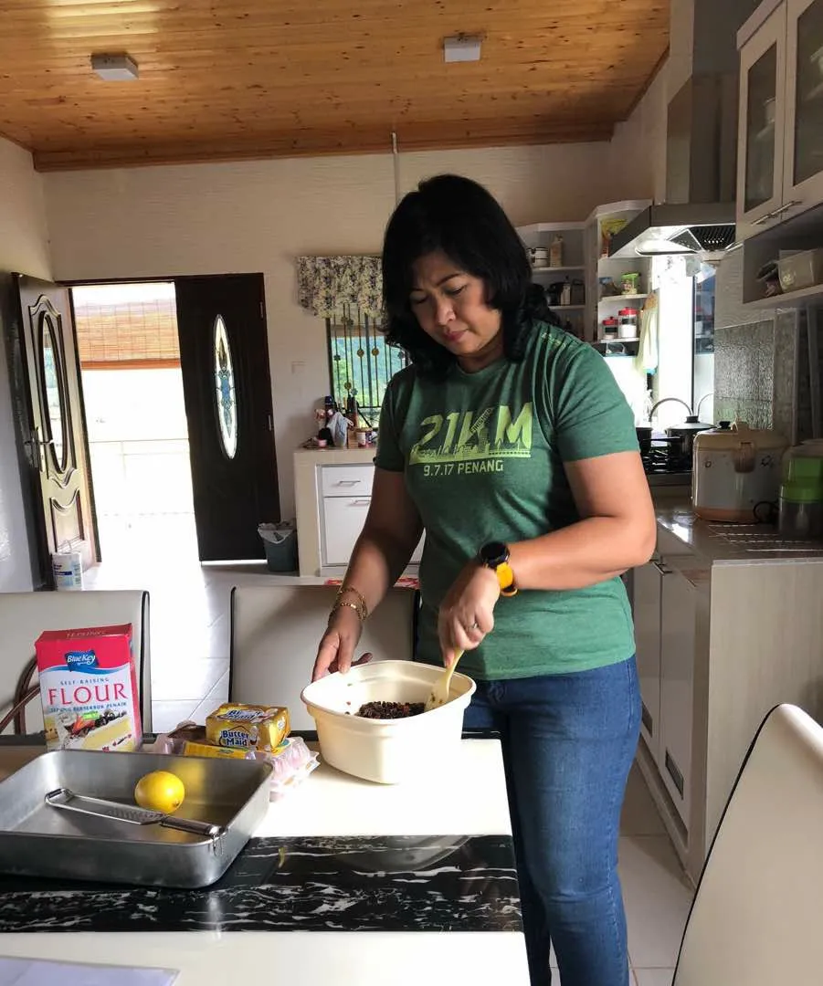 Janet in her kitchen getting ready to do mmore baking.jpg