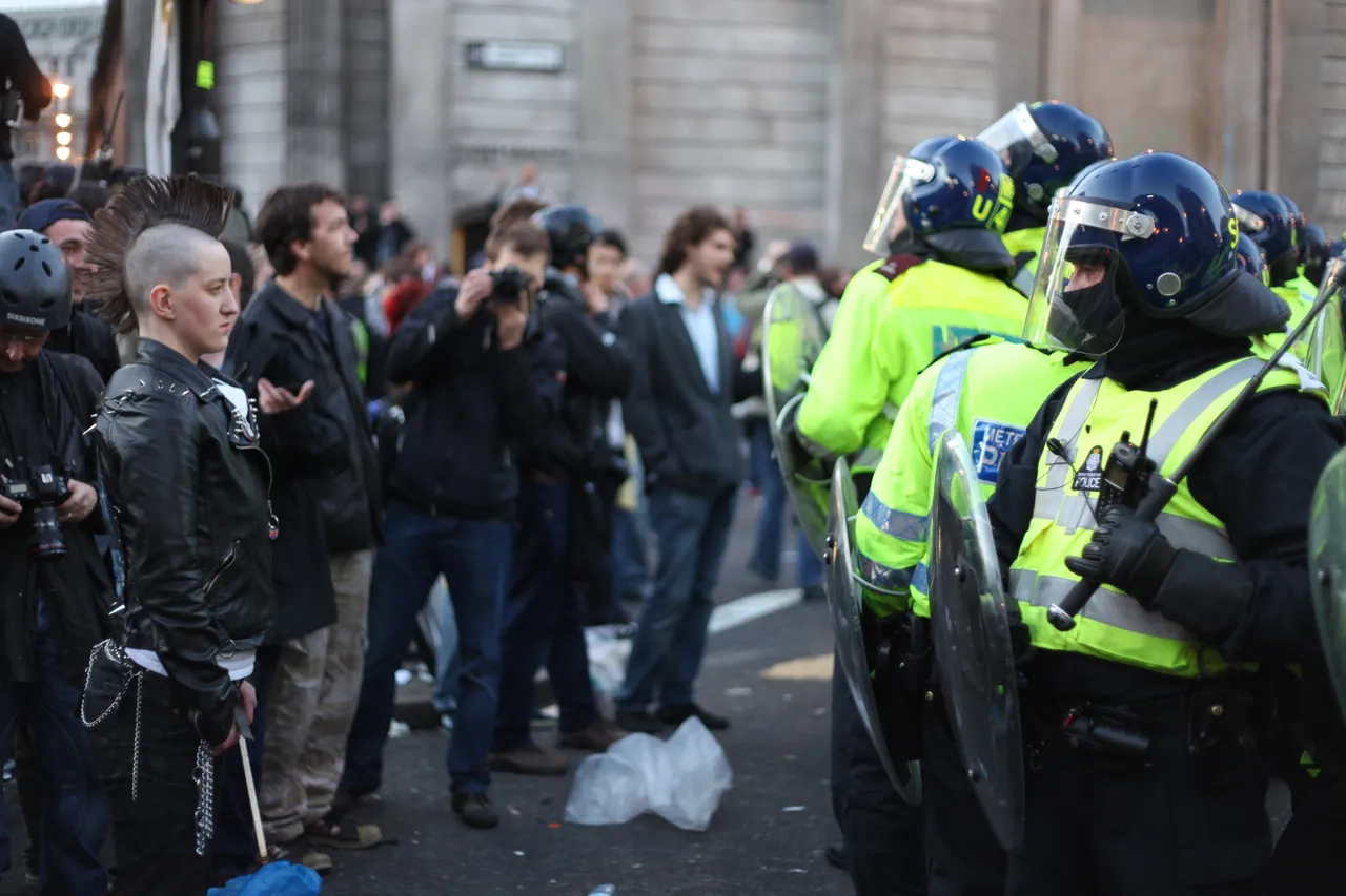 People facing off against Riot Police