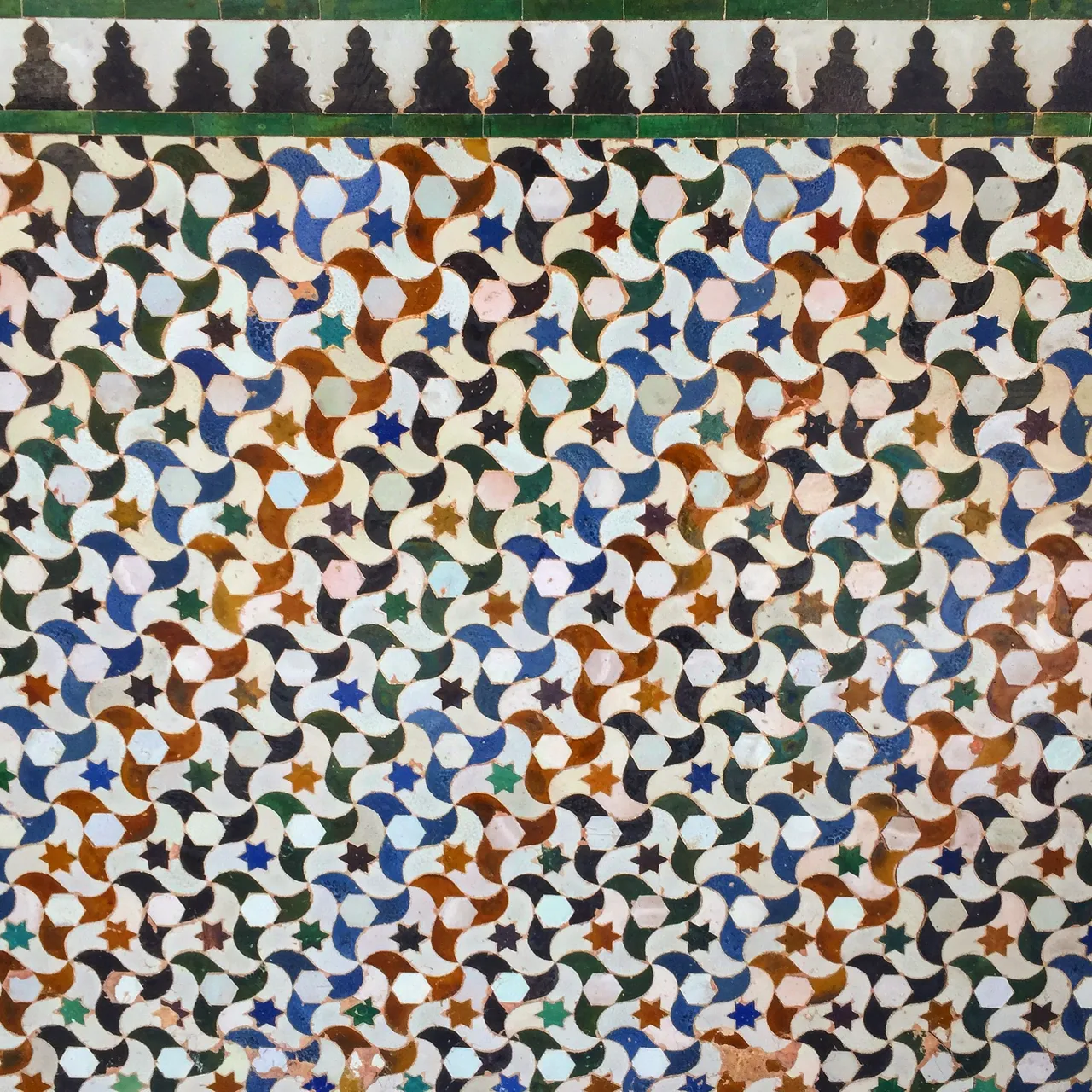 Intricate and colourful tessellation of tiles that purportedly influenced M. C. Esher's work on the subject.