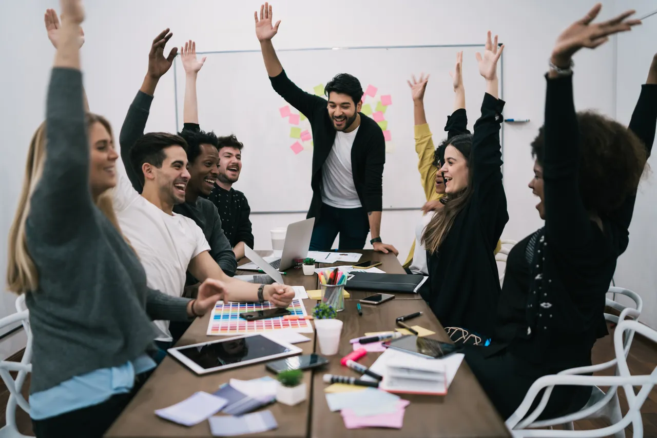 happy-business-team-celebrating-with-raised-up-hands-office-success-winning-concept.jpg