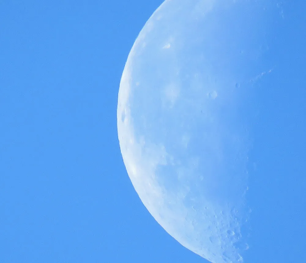 close up part of cresent moon in blue sky.JPG