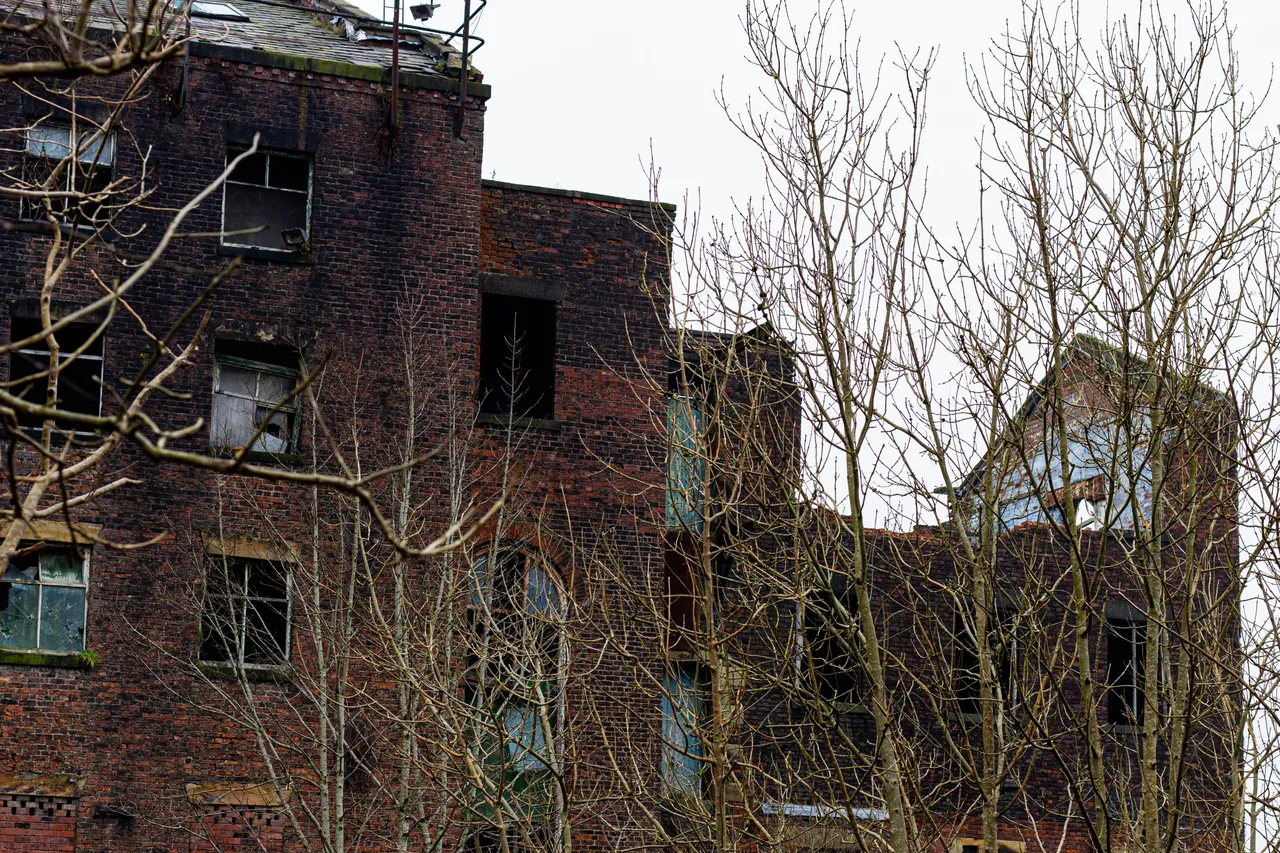 a burned and ruined part of the Old Crimble Mill factory outside the town of Heywood, Greater Manchester, England.jpg