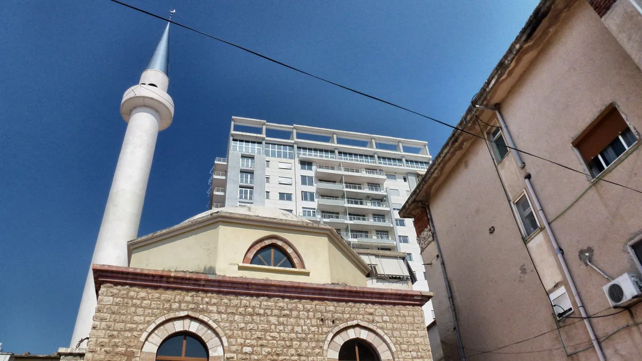 A mosque, a new build house and an old one