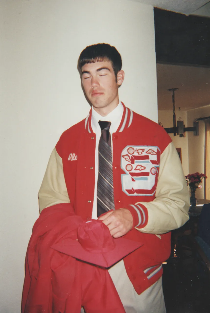 1999-06 - Alan Williams graduated from high school, in his school jacket.png