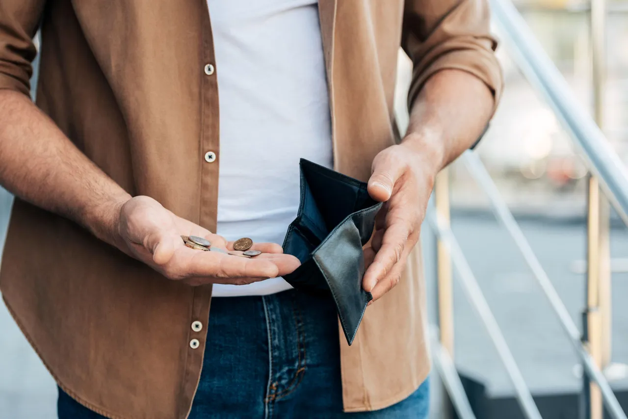 close-up-hands-holding-wallet-coins.jpg